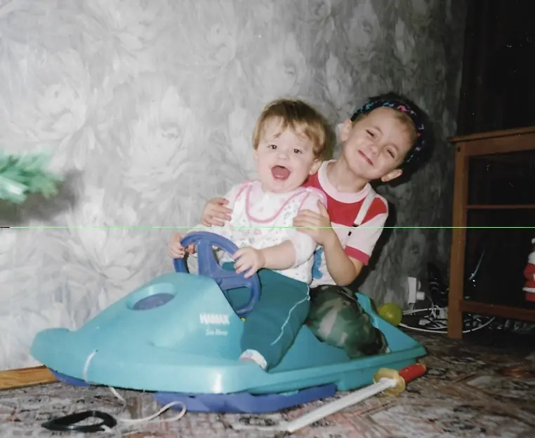 Two small boys on a plastic scooter, a photograph from 1998