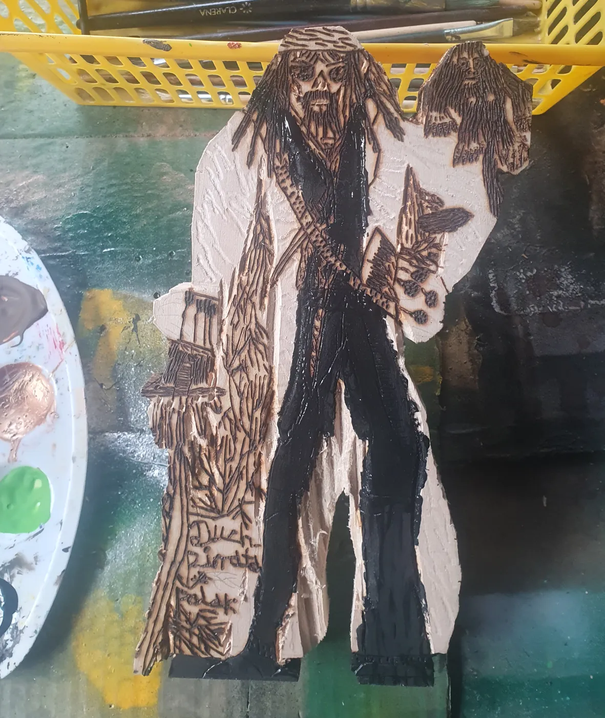 Figurka na blacie obok koszyka z pędzlami i palety; spodnie i kamizelka pirata są już czarne